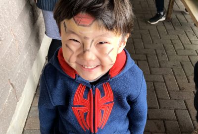 Camper smiling with face paint on