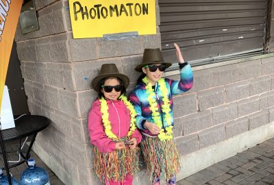 Campers smiling at the fun fair photobooth