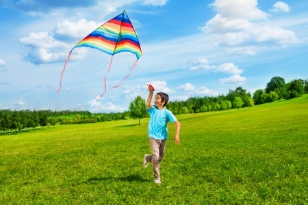 child flying a kite independently